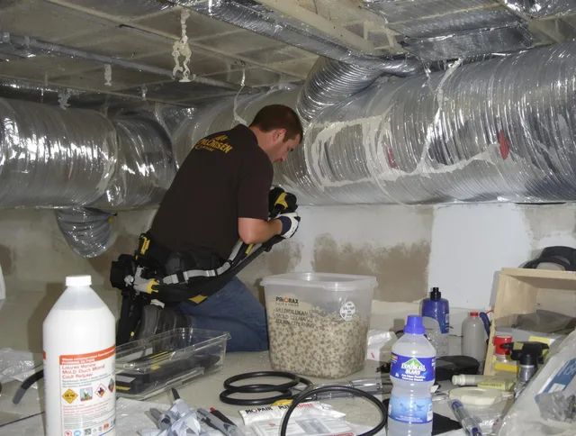 Tiverton Air Duct Cleaning specialist performing professional mold removal from air ducts in Tiverton