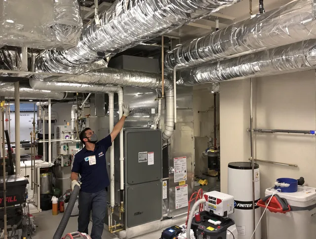 Tiverton Air Duct Cleaning specialist performing thorough furnace duct cleaning in a Tiverton residence