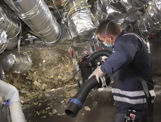 Tiverton Air Duct Cleaning specialist operating negative pressure cleaning equipment for thorough duct maintenance in Tiverton