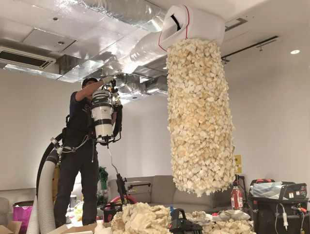 Tiverton Air Duct Cleaning technician performing precision vacuum insulation removal in a residential property in Tiverton